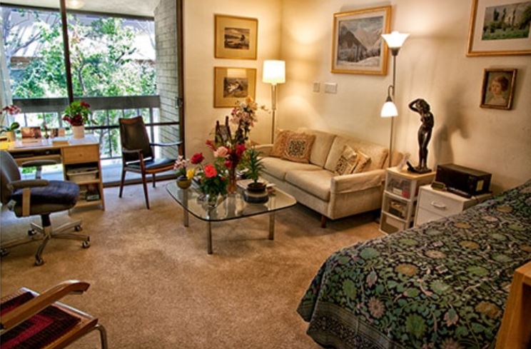 Cozy resident room with sitting area and artwork