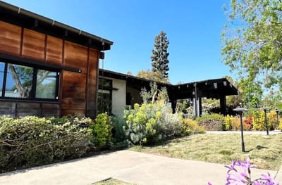 Exterior view of Oak Tree Lodge surrounded by greenery