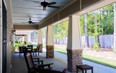 Covered patio area with seating and views of garden