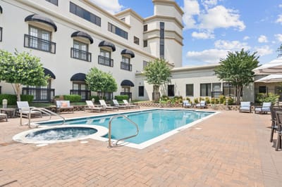 Outdoor pool area with loungers and greenery