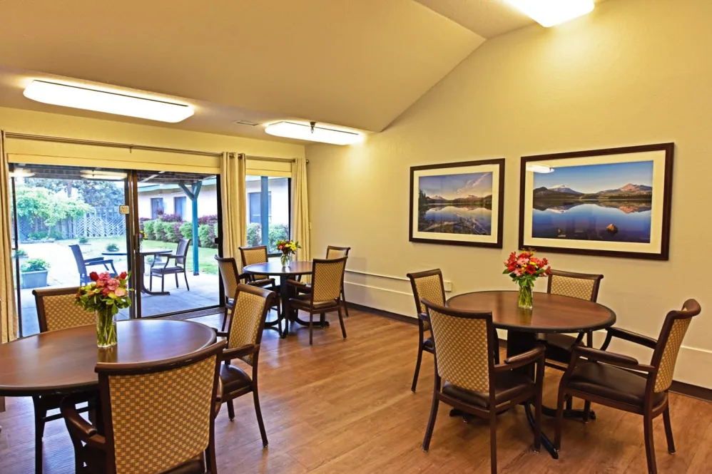Bright common area with tables and flowers