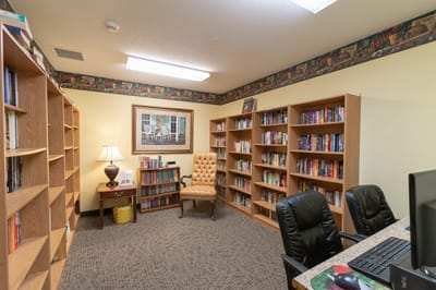 Cozy library area with bookshelves and reading chair