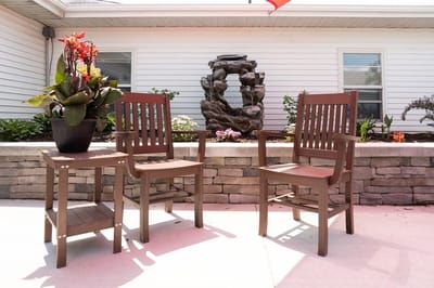 Outdoor seating area with plants and a water feature