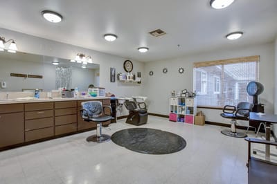 Interior view of a salon area with chairs and mirrors