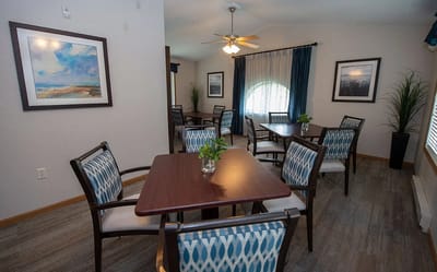 Bright common area with dining tables and chairs
