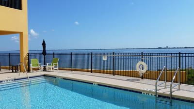 A serene outdoor pool with waterfront view