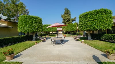 Outdoor patio area with seating and shade