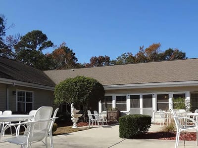 Outdoor seating area with trees and clear sky