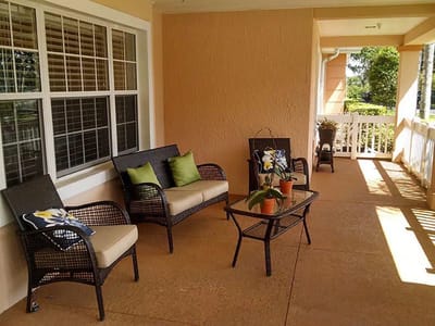 Outdoor seating area with plants and cushions