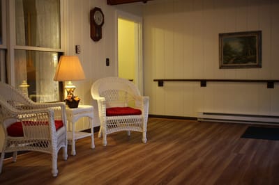 A cozy seating area with chairs and a lamp