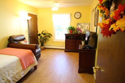 Cozy resident room with a comfortable bed and plants