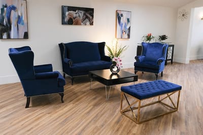 Cozy common area with blue furniture and artwork