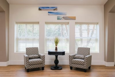 Bright common area with seating and window views