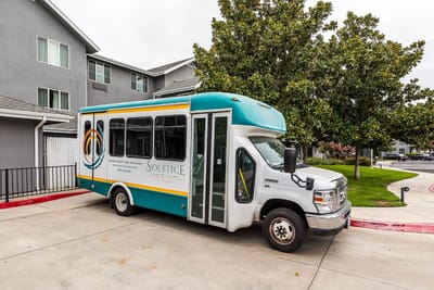 Facility transport shuttle in front of building