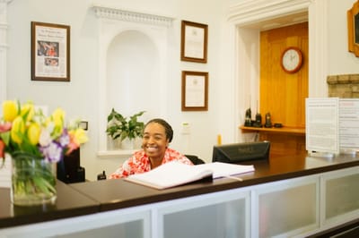 Reception area with a smiling staff member