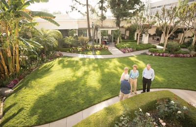 Residents enjoying time in a beautifully landscaped garden