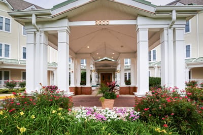 Entrance of the facility surrounded by colorful flowers