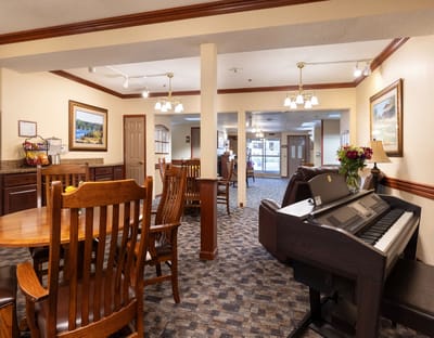 Common area with piano and dining tables