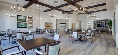 Brightly lit dining room with tables and chairs