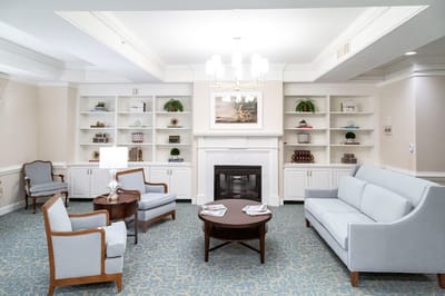 Bright common area with seating and fireplace