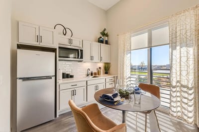 Cozy kitchen area with dining table in an assisted living unit