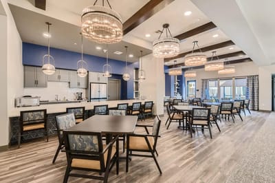 Bright dining area with modern furnishings and chandeliers