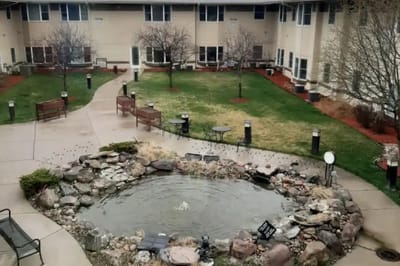 Outdoor courtyard with a pond and benches
