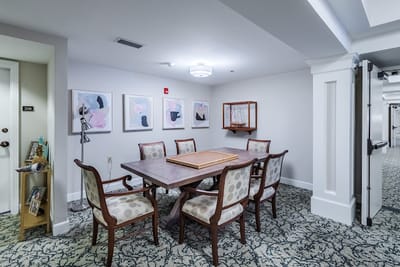Bright meeting space with a large table and artwork.