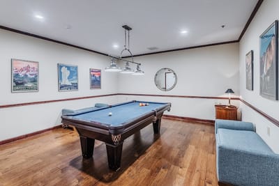 Billiards room with a pool table and chairs