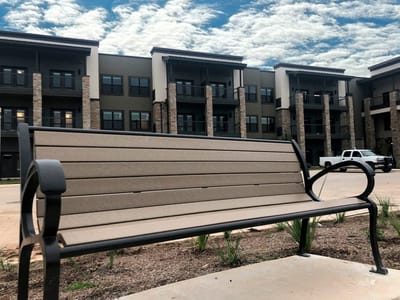 Outdoor bench in front of a residential building