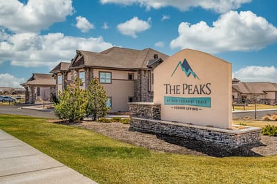 Exterior view of The Peaks at Old Laramie Trail sign