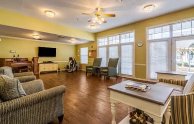 Bright common area with seating and a piano