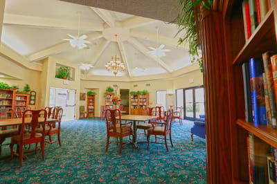 Interior view of a common area with tables and bookshelves