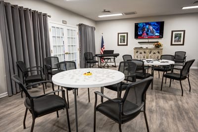 Interior activity room with tables and seating