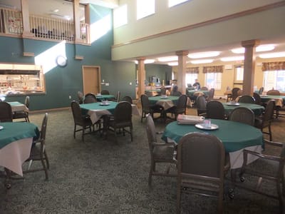 Dining area with tables and chairs set up for meals
