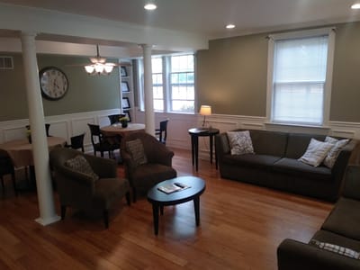 Common area with seating and tables in a bright room
