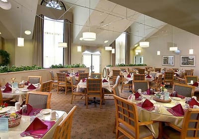 Dining room set up with tables and chairs for meals
