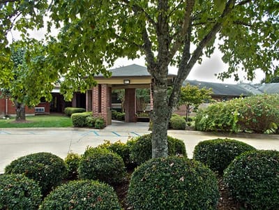 Entrance of Traceway Retirement Community surrounded by greenery