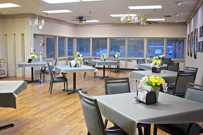 Bright dining room with tables set for meals