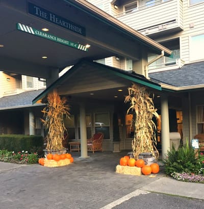 Entrance decorated for fall with pumpkins and hay