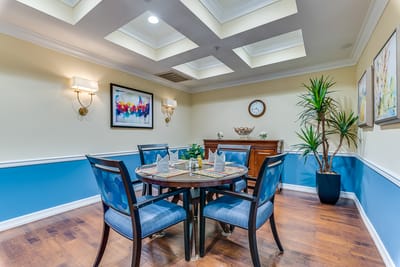 Bright common area with a round table and chairs