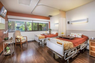 Cozy shared resident room with two beds and a window