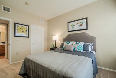 A well-decorated resident bedroom with a bed and artwork