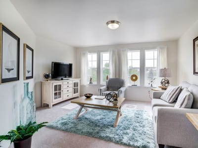 Bright common area with cozy seating and decor