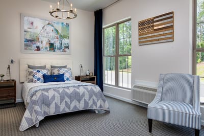 Modern resident room setup with decor and bedding