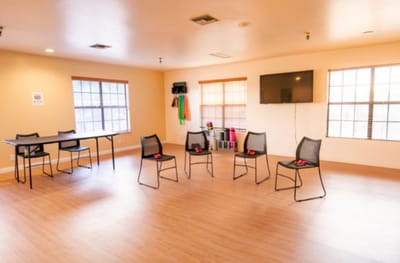 Empty activity room with chairs and exercise equipment