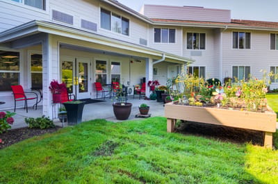 Outdoor area with flowers and seating near the facility