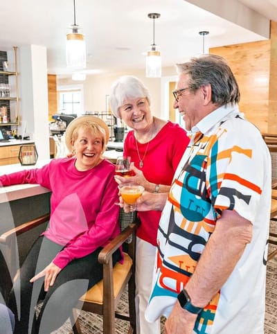 Residents socializing in a common area with drinks