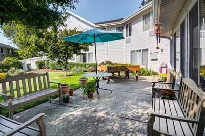 Outdoor patio area with seating and greenery