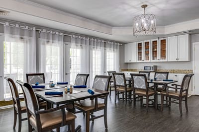 Bright dining area with tables and chairs set for a meal